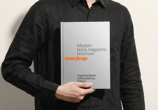 Hardcover Book Mockup Held By Man With One Hand Front View On Light Background