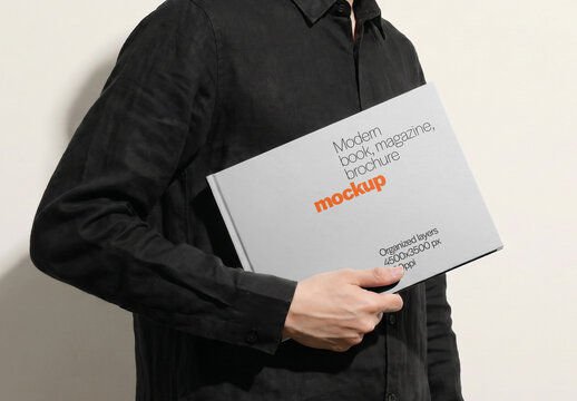 Hardcover Book Mockup Held Horizontally Under Arm By Man Side View On Light Background