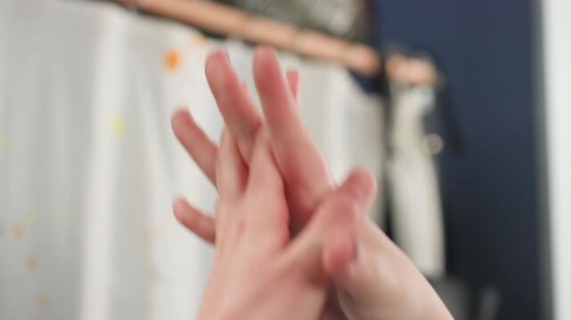 Caucasian hands interlaced practicing wheel technique in workshop, focused student repeating controlled rotations, wet clay traces, nails with polish, soft studio lighting, background apron