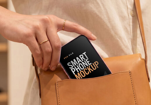 Smartphone Mockup Being Placed Into Leather Crossbody Bag In Fashion Store