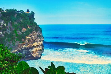      Bali, Indonesia - June 7, 2022: The Uluwatu Temple on a Cliff. Perched dramatically on a steep cliff, Uluwatu Temple stands at an elevation of 97 meters above sea level, offering breathtaking oce © Scotts Travel Photos