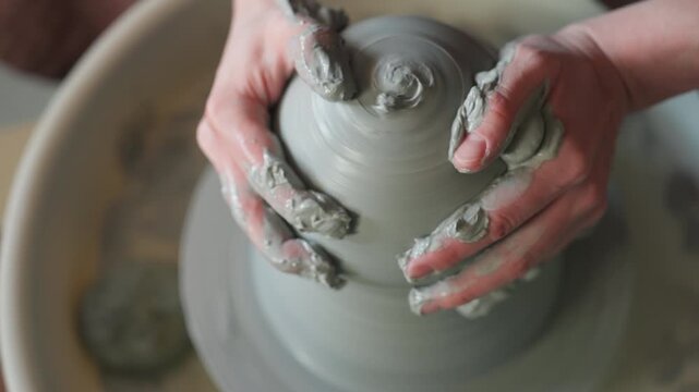 Clay molded intricately. Wet slips facilitate detailed shaping of clay through fingertip pressure. Artists carefully manipulate wet clay with detailed tools to create intricate swirling patterns