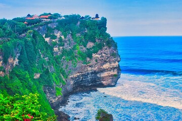      Bali, Indonesia - June 7, 2022: The Uluwatu Temple on a Cliff. Perched dramatically on a steep cliff, Uluwatu Temple stands at an elevation of 97 meters above sea level, offering breathtaking oce © Scotts Travel Photos