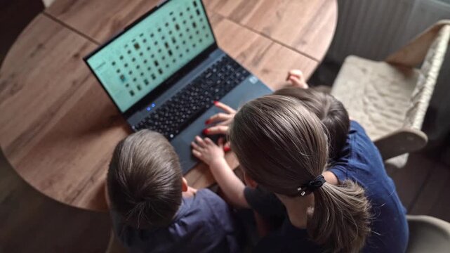 Overhead view of parent and child using laptop on wooden table, cozy living room light, hands on keyboard, focused tutoring moment, subtle emotional bond, stepbystep guidance, modern digital