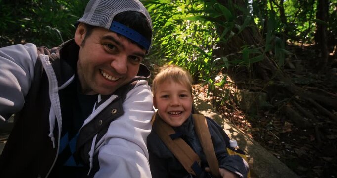 Father and son doing a selfie on old steps of Japanese village forest