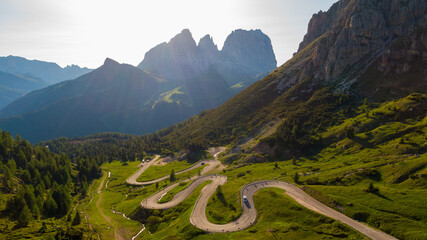 Golden hour aerial view of a Dolomites Passo Pordoi mountain pass village in Italy © Kadosa