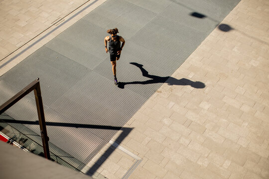 Runner enjoys a sunny workout on a peaceful city street in the morning