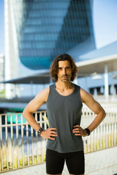 Strong individual showcases fitness in modern urban environment during daylight