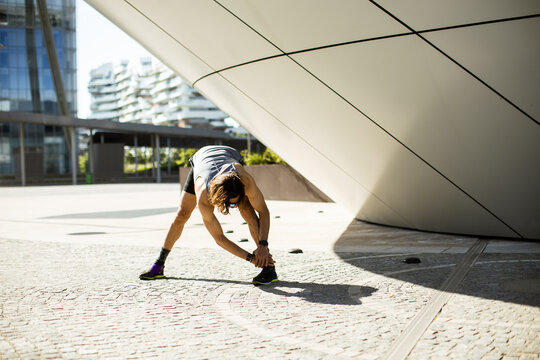 Stretching before an active day in a modern urban setting