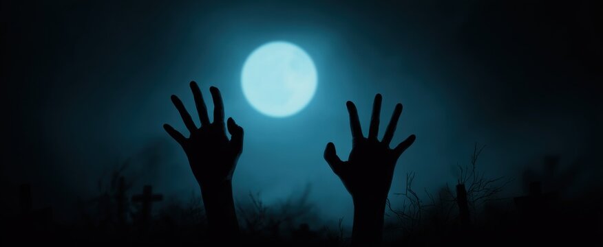Chilling silhouette of monstrous zombie hands with sharp nails evokes Halloween terror from a graveyard.
