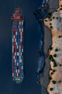3D vertical cargo ship along rocky desert coastline