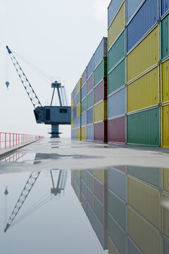3D shipping yard perspective with tall container wall