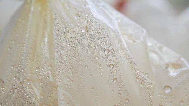 Water droplets and condensation on a plastic bag surface.