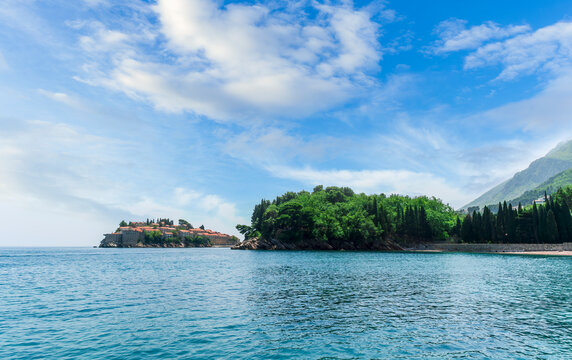 beautiful summer landscape of amazing resort on amazing island with yellow ancient walls and orange tile roofs among sea vawes and nice blue sky on background