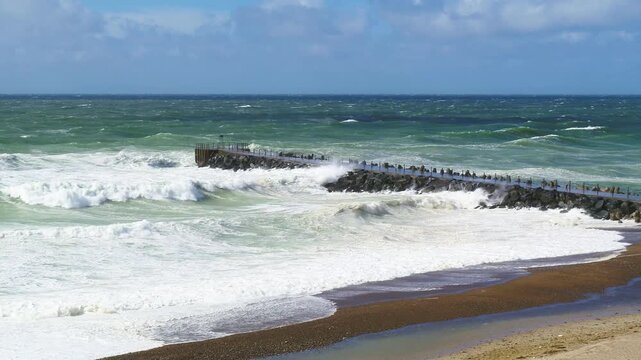 Crazy waves crashing hitting a pier at the North Sea in Denmark