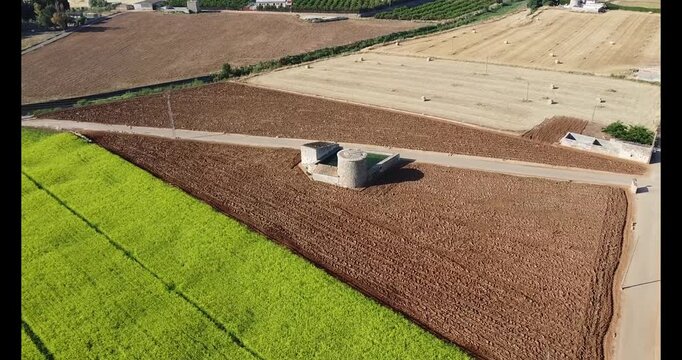 Agricultural landscape aerial view farmland and watermills in sa pobla mallorca drone shot of Rural Fields and Traditional Structures