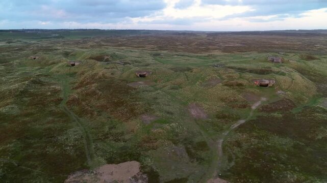 Drone panning over World War 2 bunkers in dunes at the Danish West coast