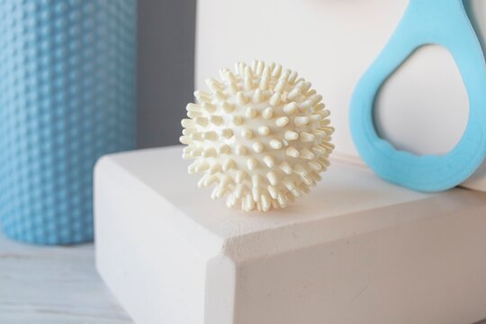 Equipment for yoga and pilates. Yoga blocks, roller, expander and massage ball on a wooden surface.