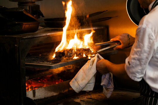 Grilling With Passion at a Vibrant Outdoor Kitchen During a Summer Evening