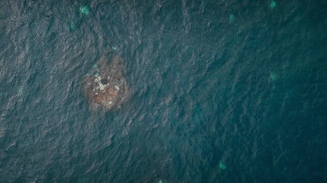 Aerial top view of Atlantic ocean surface with subtle wave patterns over reef. Natural water texture and motion