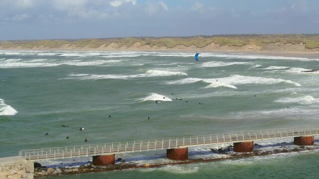 Short clip of surfers and kitesurfers at sea