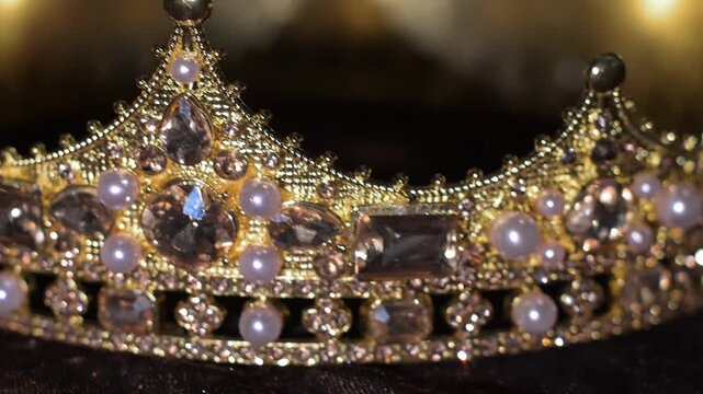 Luxury Golden Crown with Gemstones and pearls on Dark Velvet Background. Elegant luxury golden crown adorned with radiant yellow gemstones placed on a dark velvet texture background. Soft light reflec