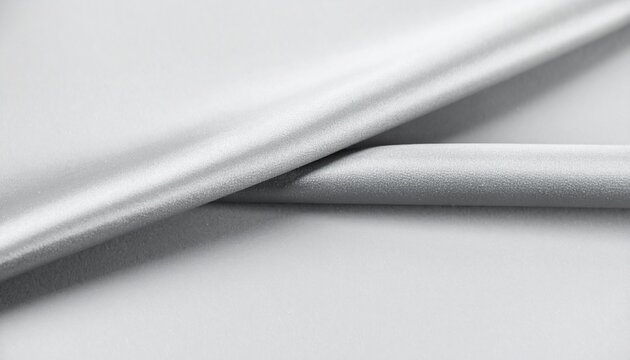 Elegant abstract background of soft grey textured material with smooth folds and gentle light.