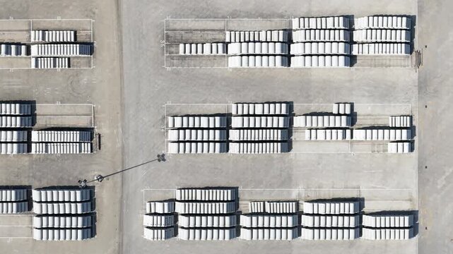 Aerial view of concrete manholes stored in industrial yard