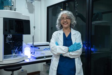 Successful female doctor or scientists standing at table, looking at camera.