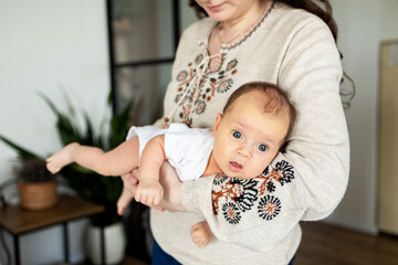 Fototapeta premium Newborn in mother's hands. Baby care. Childbirth and motherhood concept. Mother and baby.
