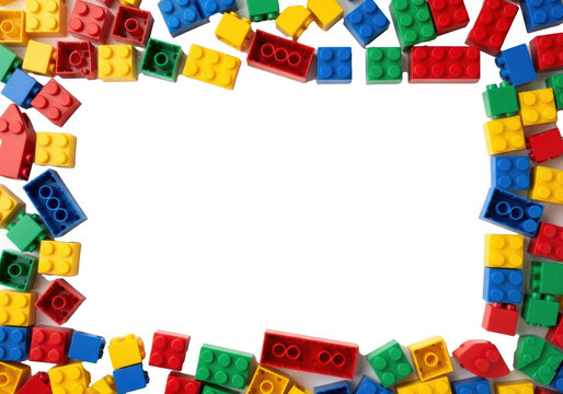 Vibrant red, yellow, green, blue plastic toy building blocks, like classic LEGO, scattered on transparent, central copy space, top-down studio shot with no shadows. Concept of childhood creativity