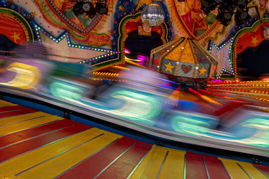Amusement park ride spinning at a funfair at night