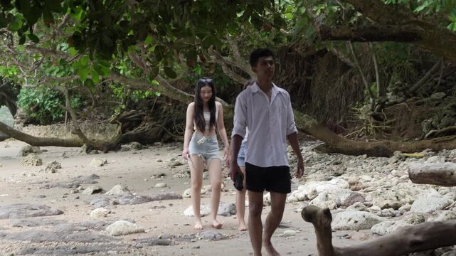 Young Friends Walking Along Tropical Beach in Yogyakarta Indonesia