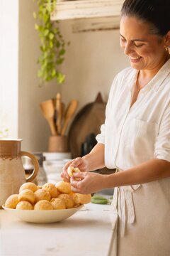 Authentic Brazilian P o de Queijo, a traditional tapioca starch cheese bread, freshly baked and served warm in a cozy cafe setting with a candid, motion-blurred hand reaching for a