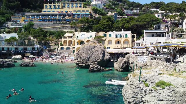 Wide drone panorama of Marina Piccola and southern Capri shoreline in summer