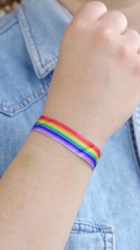 Woman lesbian pride rights with gay pride bracelet. LGBT and equal rights