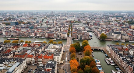 Obraz premium Aerial view of a European city with canals bridges and autumn trees boats on water