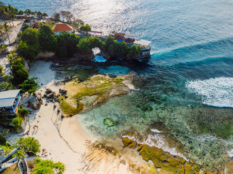 Drone view of tropical peninsula with cliffs and turquoise ocean