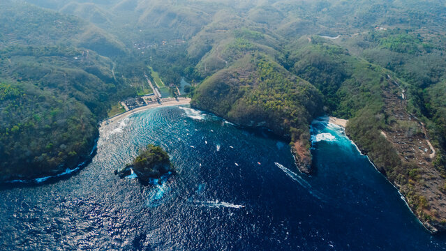 Drone view of dramatic tropical bays surrounded by green hills in Nusa Penida