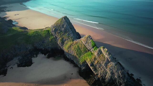 Sunrise at Three Cliffs Bay in Wales. Drone flight