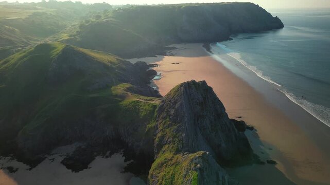 Sunrise at Three Cliffs Bay in Wales. Drone flight