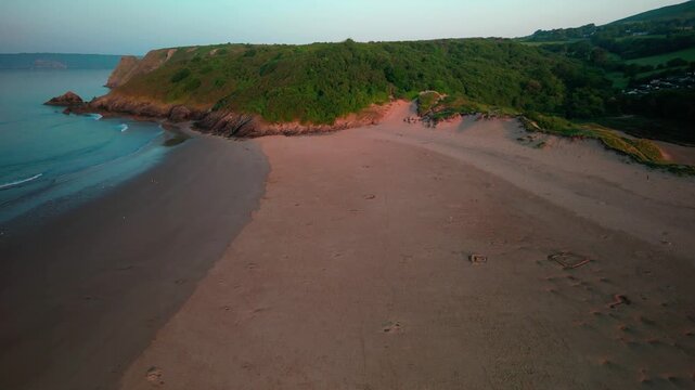 Sunrise at Three Cliffs Bay in Wales. Drone flight