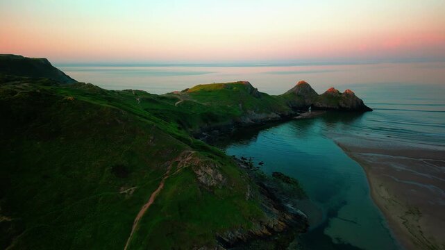 Sunrise at Three Cliffs Bay in Wales. Drone flight