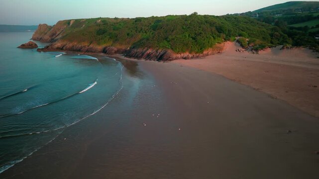 Sunrise at Three Cliffs Bay in Wales. Drone flight