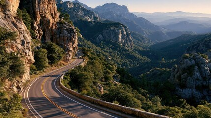 Fototapeta premium Winding road hugs mountain cliffs at sunrise