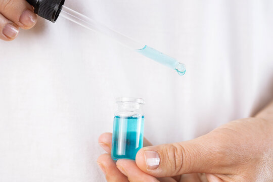 ghk cu peptide liquid pipette vial hands alternative mots c injection cosmetology close up view looking away concept of biochemistry, healthcare, pharmacology