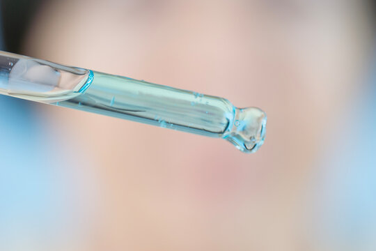 dropper with copper peptide serum ghk cu macro pipette glass vial liquid blue fluid substance cosmetic chemistry sample testing anti aging formulation clinical laboratory concept of biochemistry
