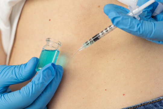 ghk cu peptide vial pipette subcutaneous belly fold injection syringe hands analog mots c therapy close up view looking away concept of cosmetology, biochemistry, pharmacology