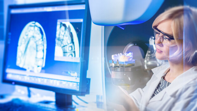 Dental technology, prosthetic design. Specialist scans dental model and analyzes digital tooth images for CAD CAM restoration.