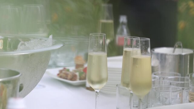 Selective focus on a hand with dessert fork taking tropical fruit at a festive dinner party